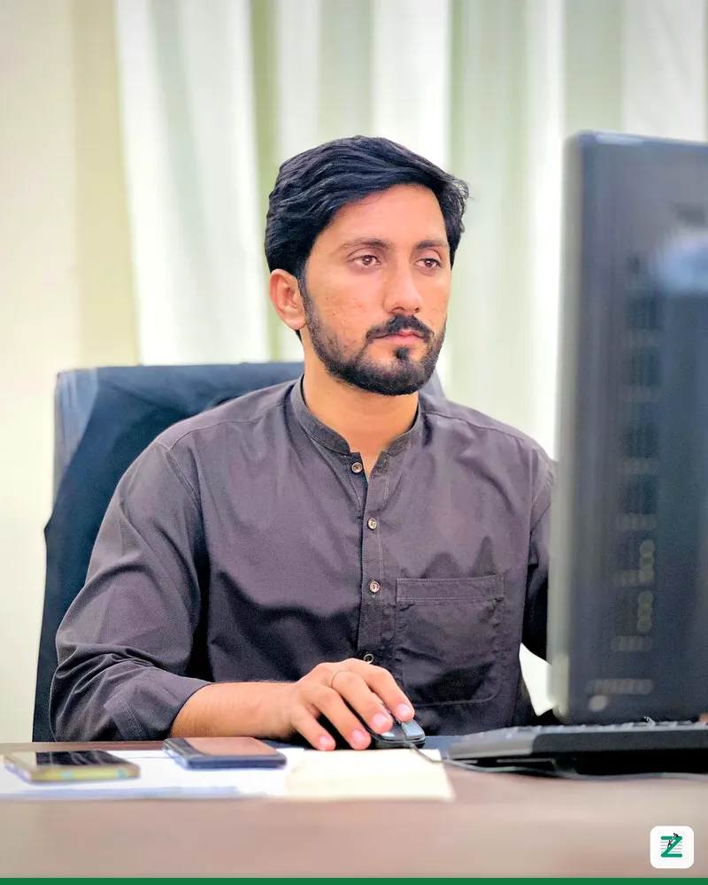 Trainer working at his computer at Zentyro Digital training institute, Multan