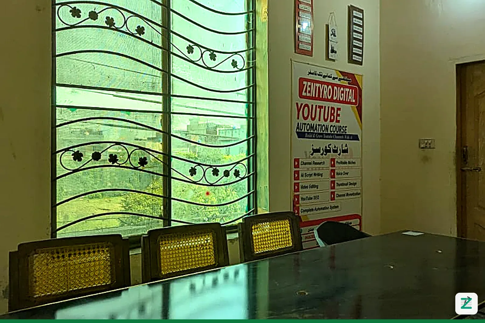 Classroom at Zentyro Digital with the YouTube Automation Course poster on the wall